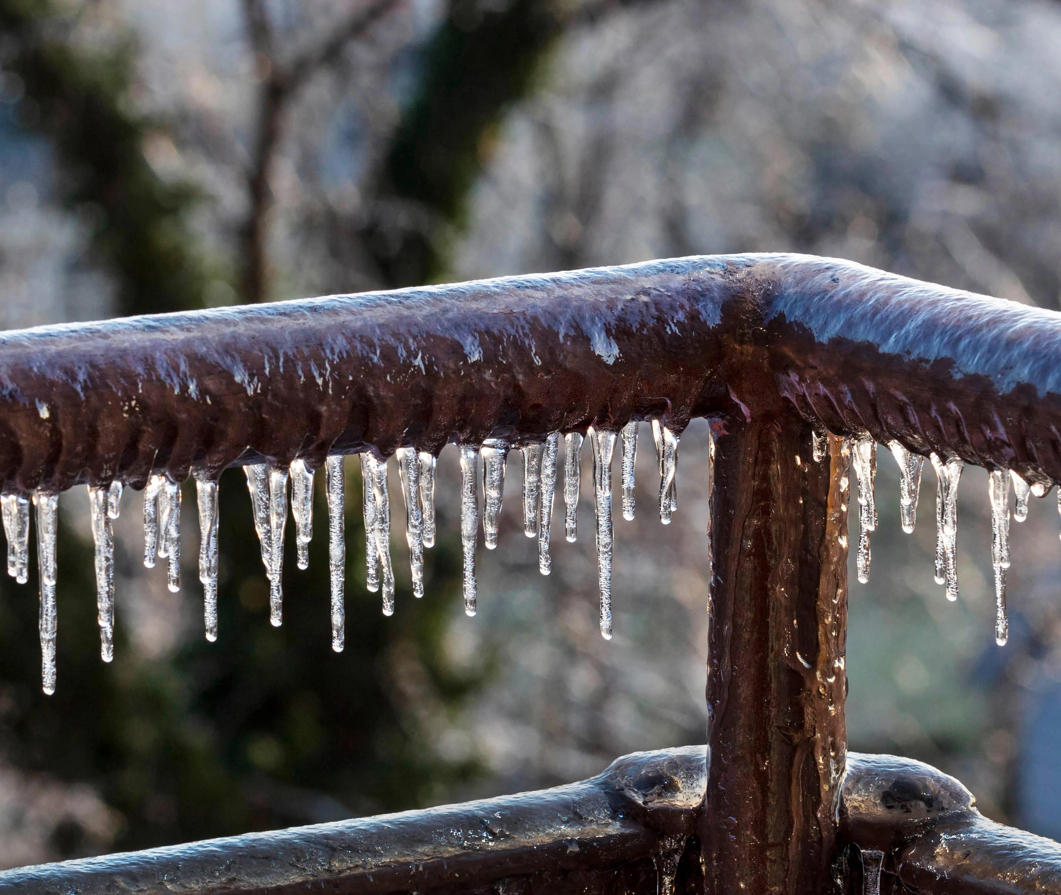 Icicles on balcony railing in morning sun