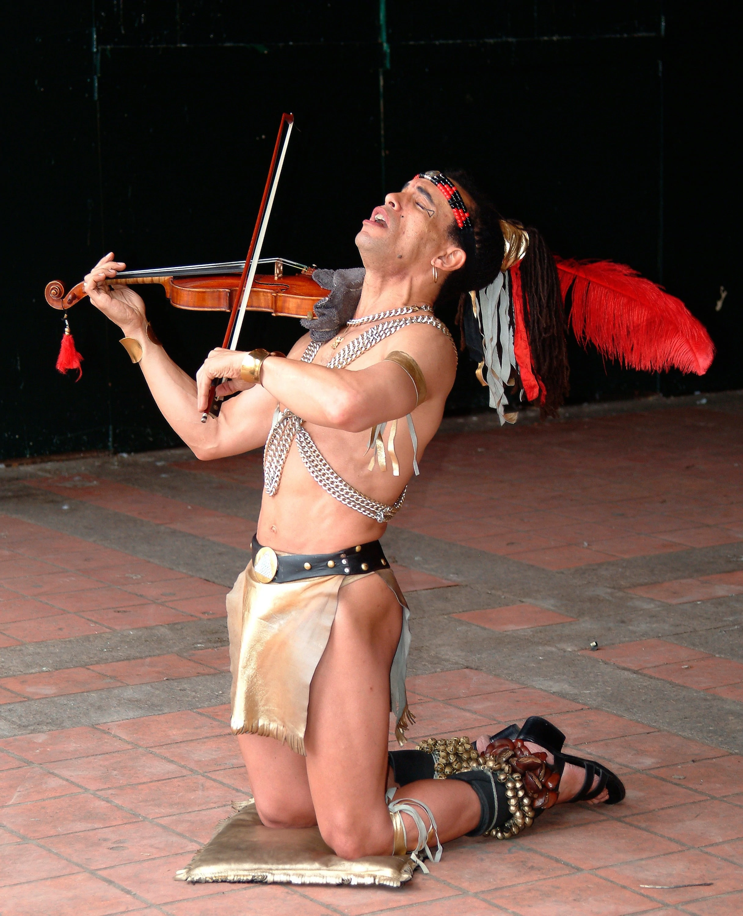 Central Park Street Performer, violin, feathers, leather loincloth