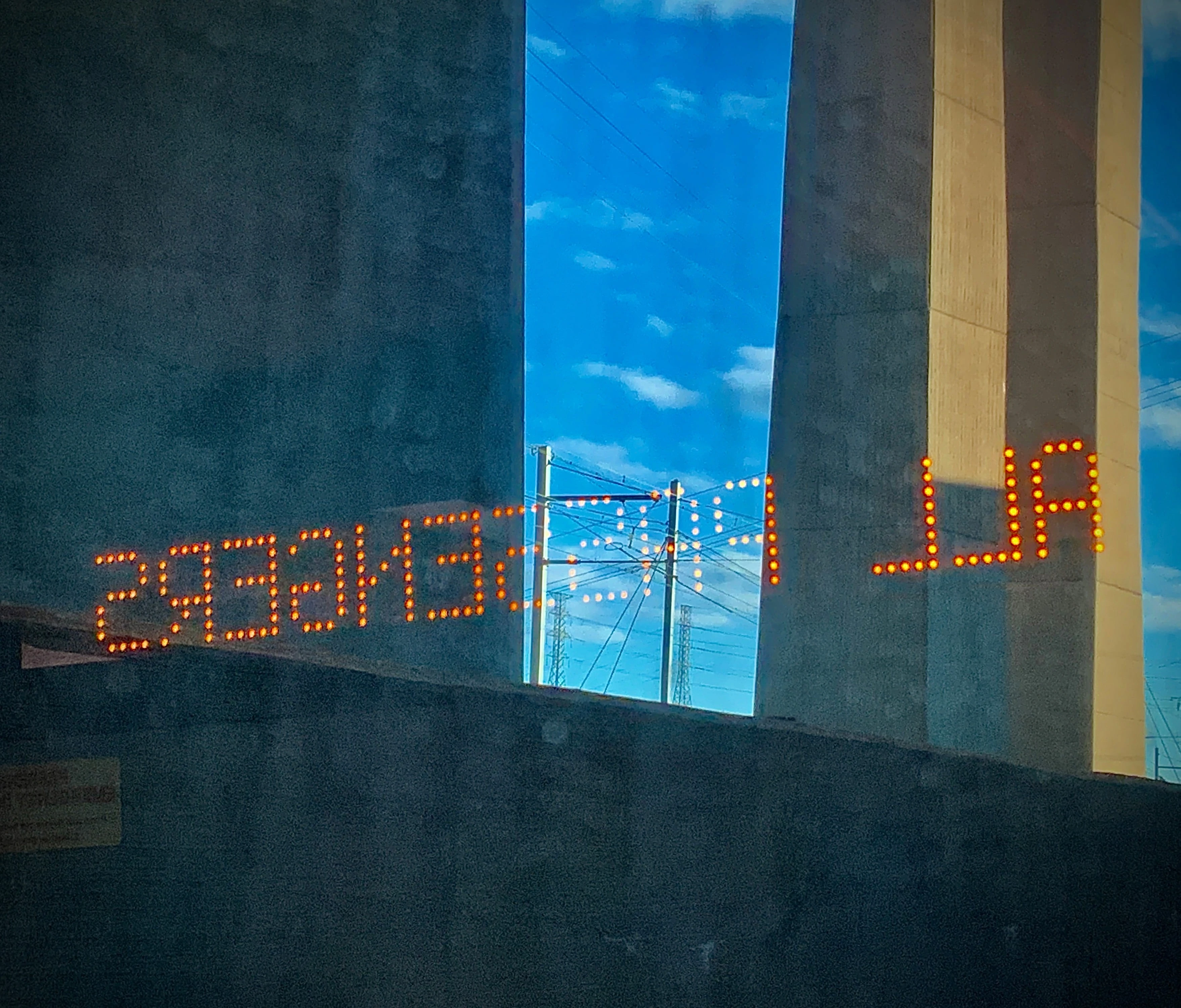 OUT THE WINDOW: View from a New York bound New Jersey Transit Train with reflection of interior signage
